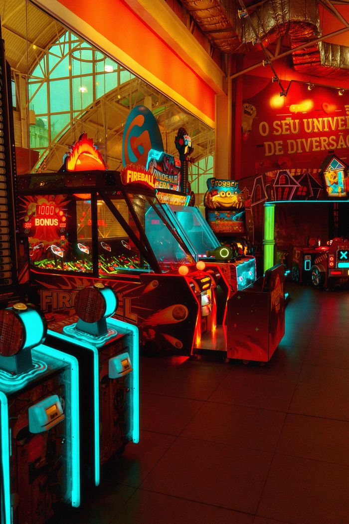 heros-img Explore a colorful and vibrant neon-lit arcade with various gaming machines for an exhilarating experience.